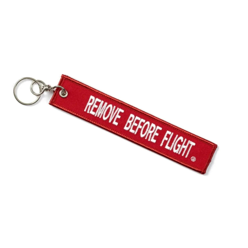 A red remove before flight keychain. It has the words "boeing 747-8" written on it.