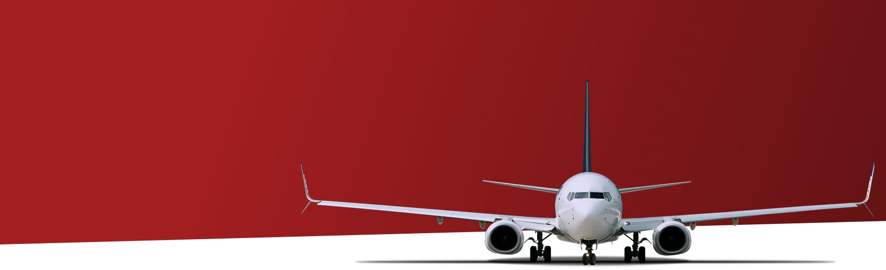 An airplane in front of a red and white background.