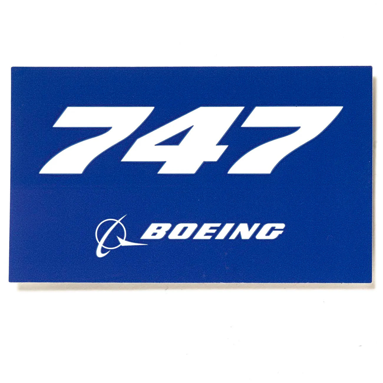 A blue sticker with 747 and Boeing printed on it.