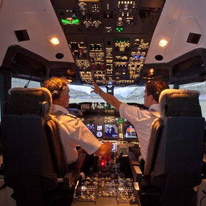 Two pilots prepare for take-off in the cockpit of a Boeing 737 flight simulator.
