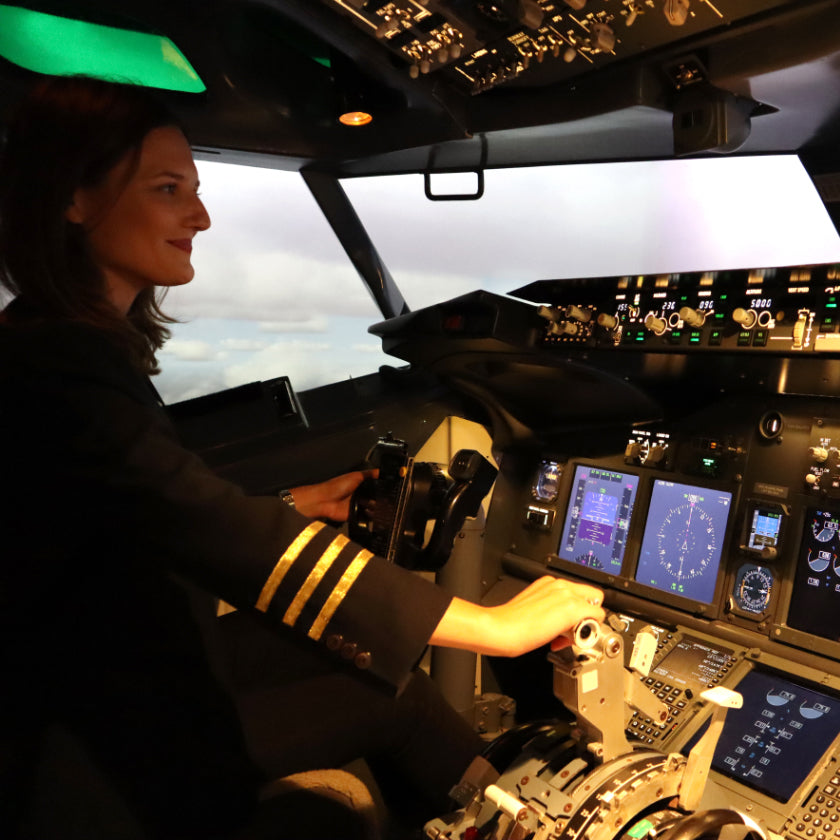 A female pilot increases the thruster of a plane simulator.