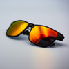 A pair of polarised pilots glasses, they are black with orange lenses.